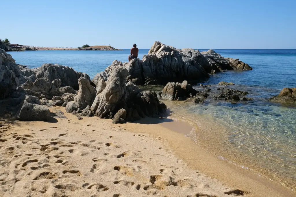 Granite rocks running into the sea at the end of the beach
